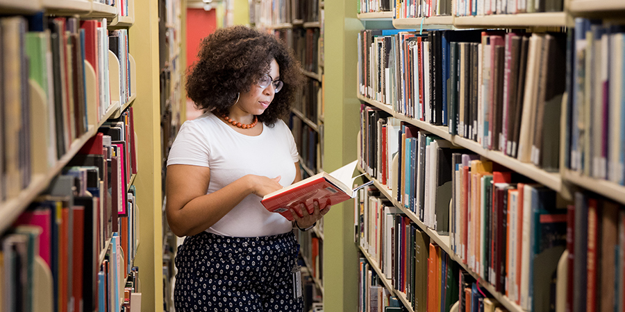 Penn’s Post-Baccalaureate programs student studying in a library
